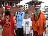 
Charlotte Ryan And Peter Ryan With two Hindu Sadhus in Kathmandu Durbar Square in 2005, with the Trailokya Mohan Narayan and Maju Deval Temples behind.

